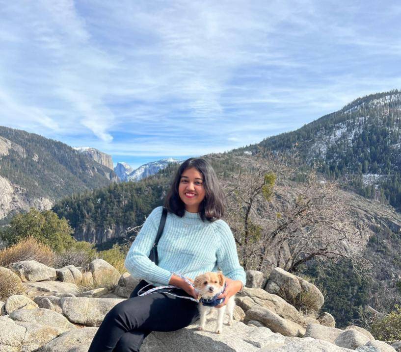 Woman sitting in front of mountains in the background